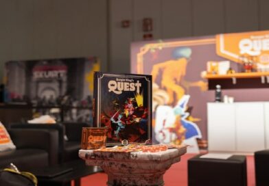 Espositore di Burger King's Quest alla Milano Games Week con manuale, carte da gioco e allestimento fantasy del regno Burger King-Dom.