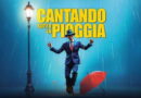Cantando sotto la pioggia a Milano al Teatro Nazionale, musical con protagonista che danza sotto la pioggia in scena iconica