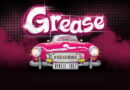 Locandina del musical Grease con auto rosa anni '50 e scritta Grease, promozione spettacolo al Teatro Repower 2026